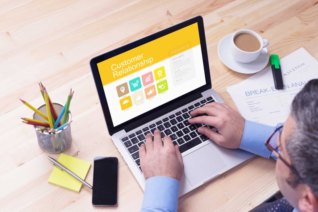 Working on a laptop with customer relations headiing