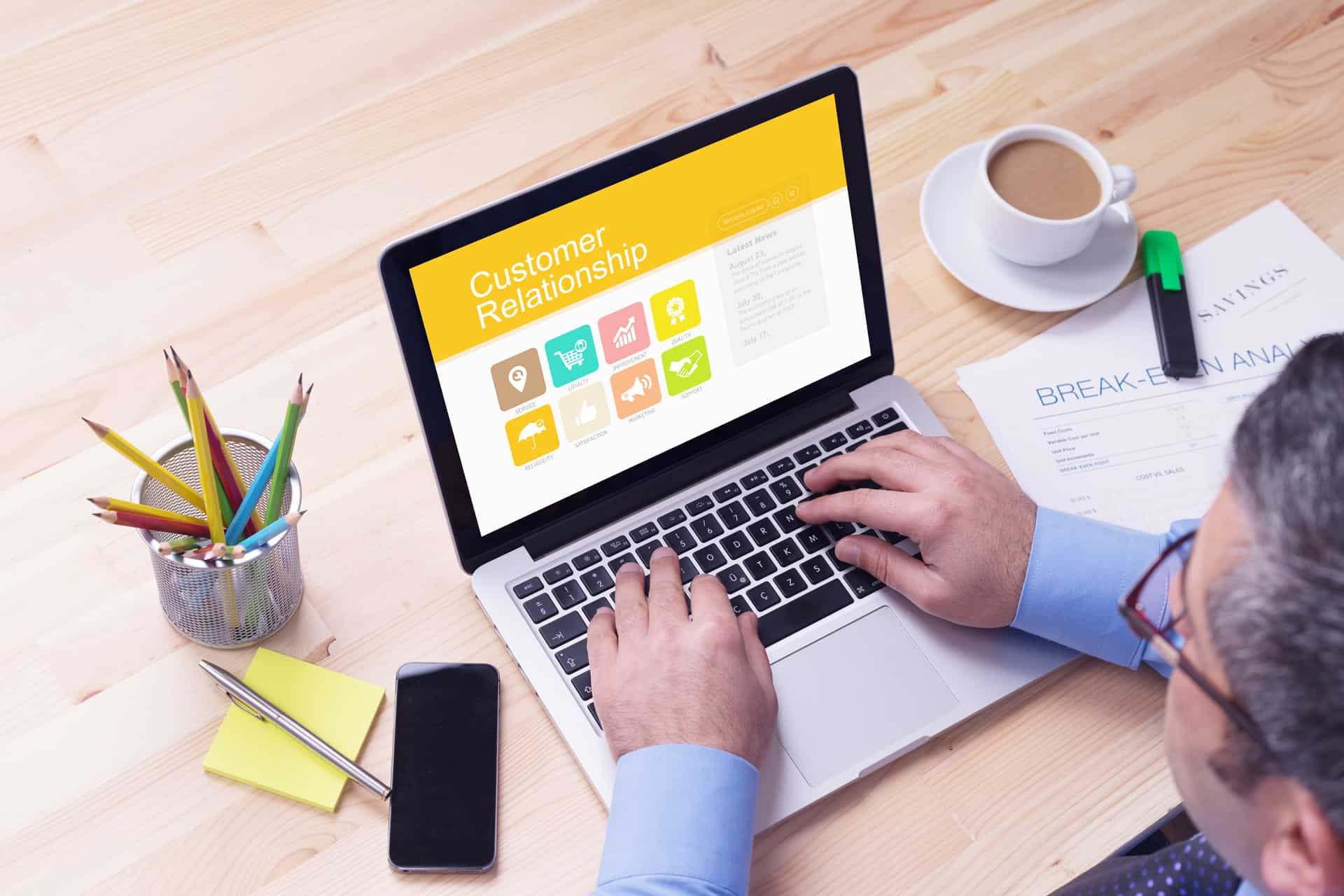 Working on a laptop with customer relations headiing