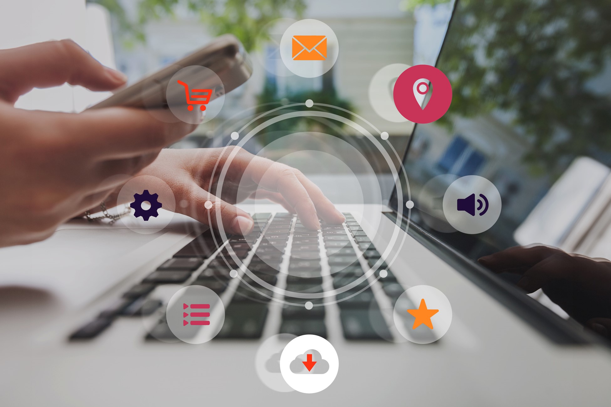 Omnichannel digital marketing concept showing hands using smartphone and laptop with icons for shopping, email, location, settings, media, downloads, and customer engagement