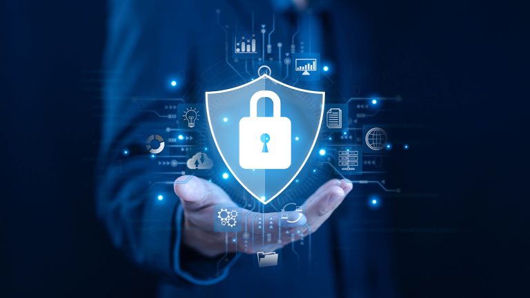 Cybersecurity concept with data protection shield and padlock icon over a businessman's hand, representing secure digital network, cloud security, and information privacy technologies.